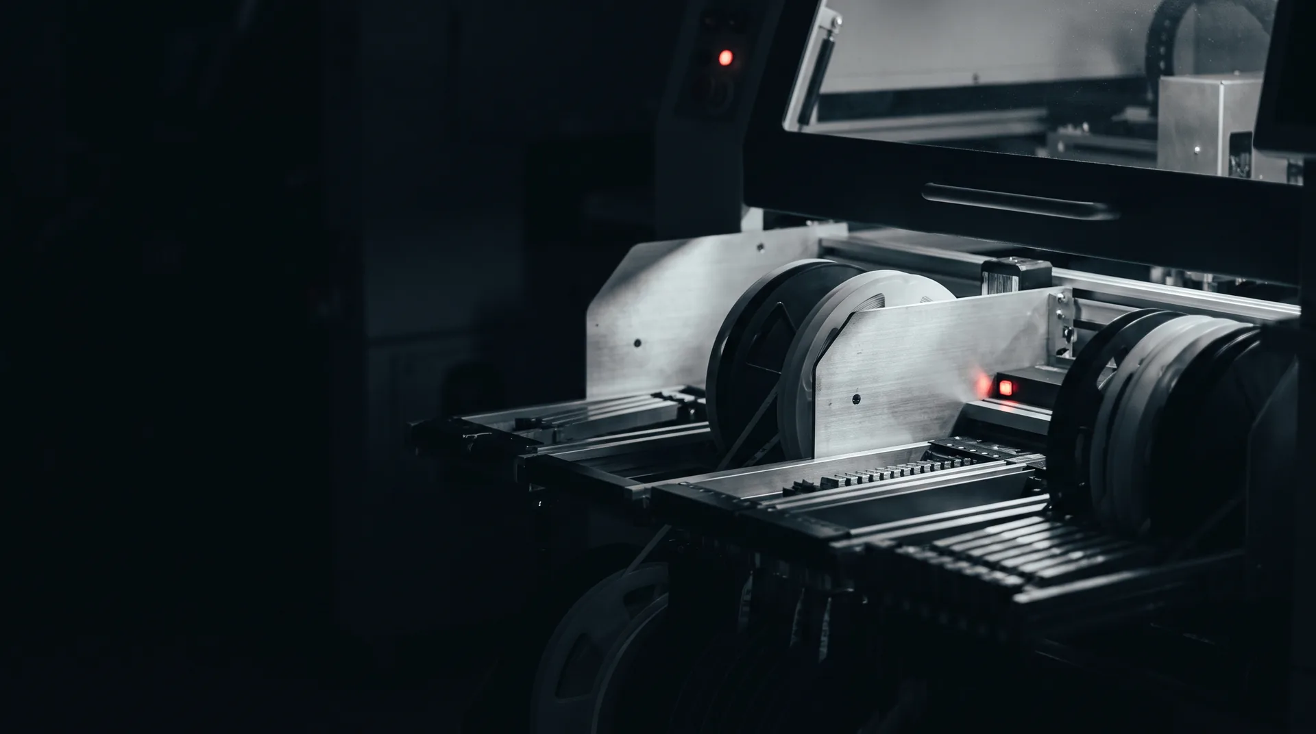 European electronics assembly line at night, component reels loaded on the pick-and-place